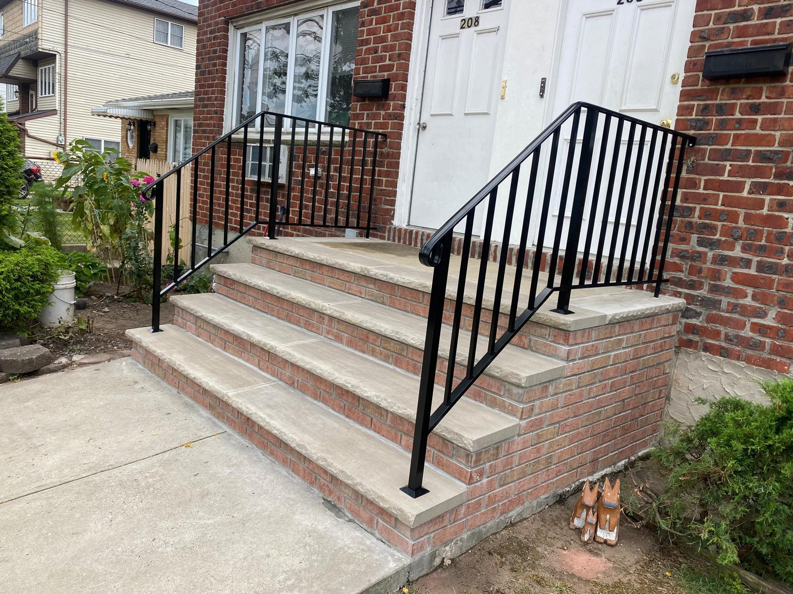 Front steps with masonry and black railings